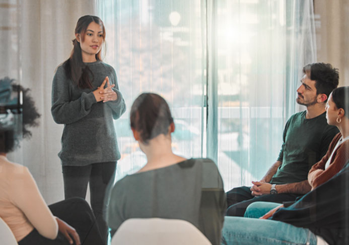 Woman standing speaking in a support group