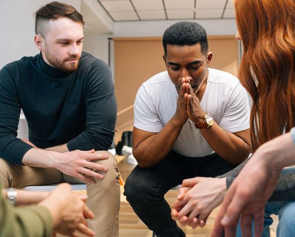 men and women in a therapy group