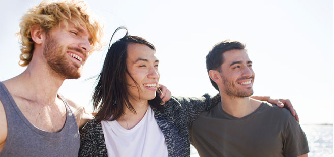 three young men smiling