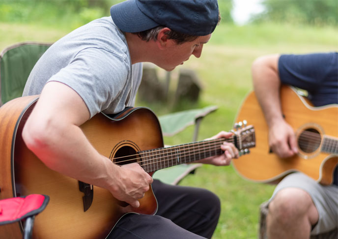 Young men playing guitars