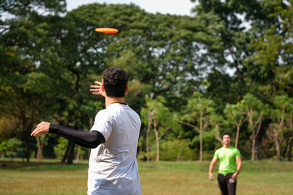 Two young men playing frisbee